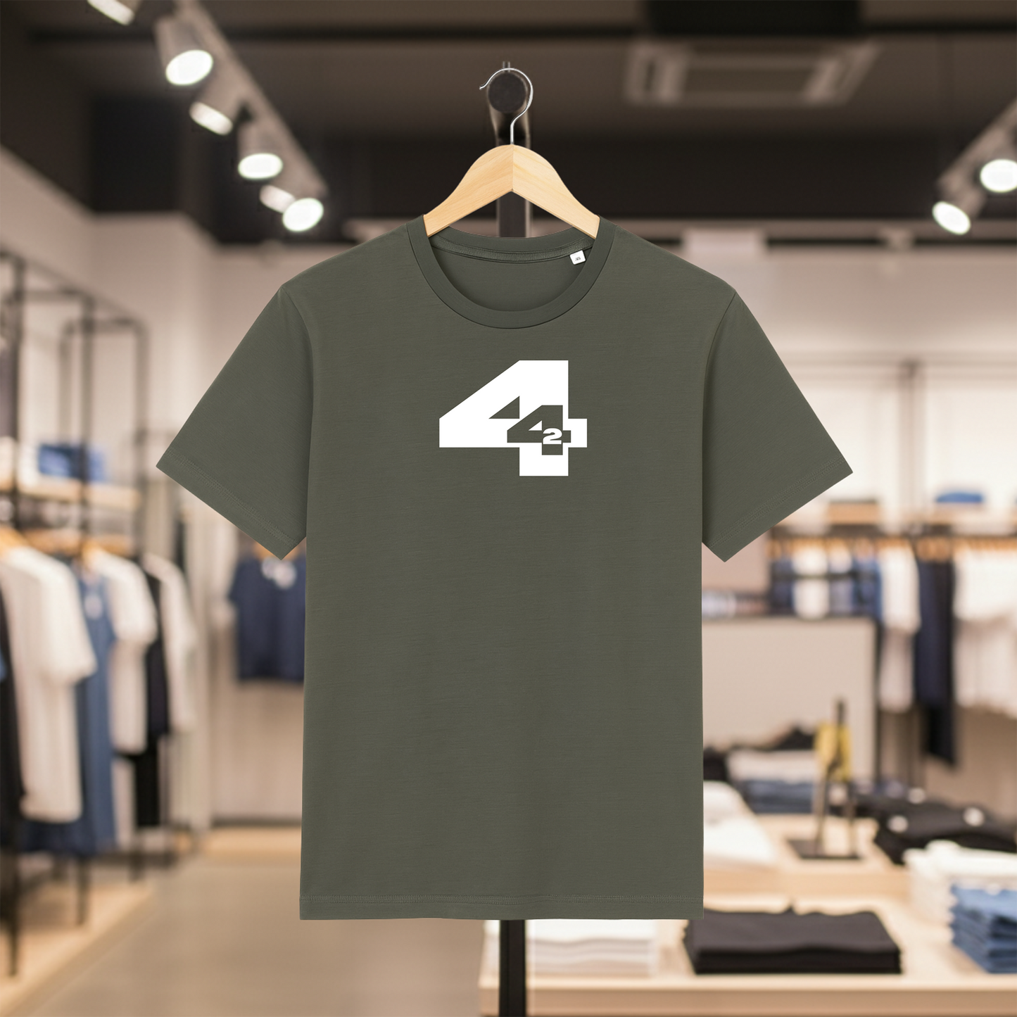 Khaki t-shirt with a white  '442' design on a hanger in a store setting