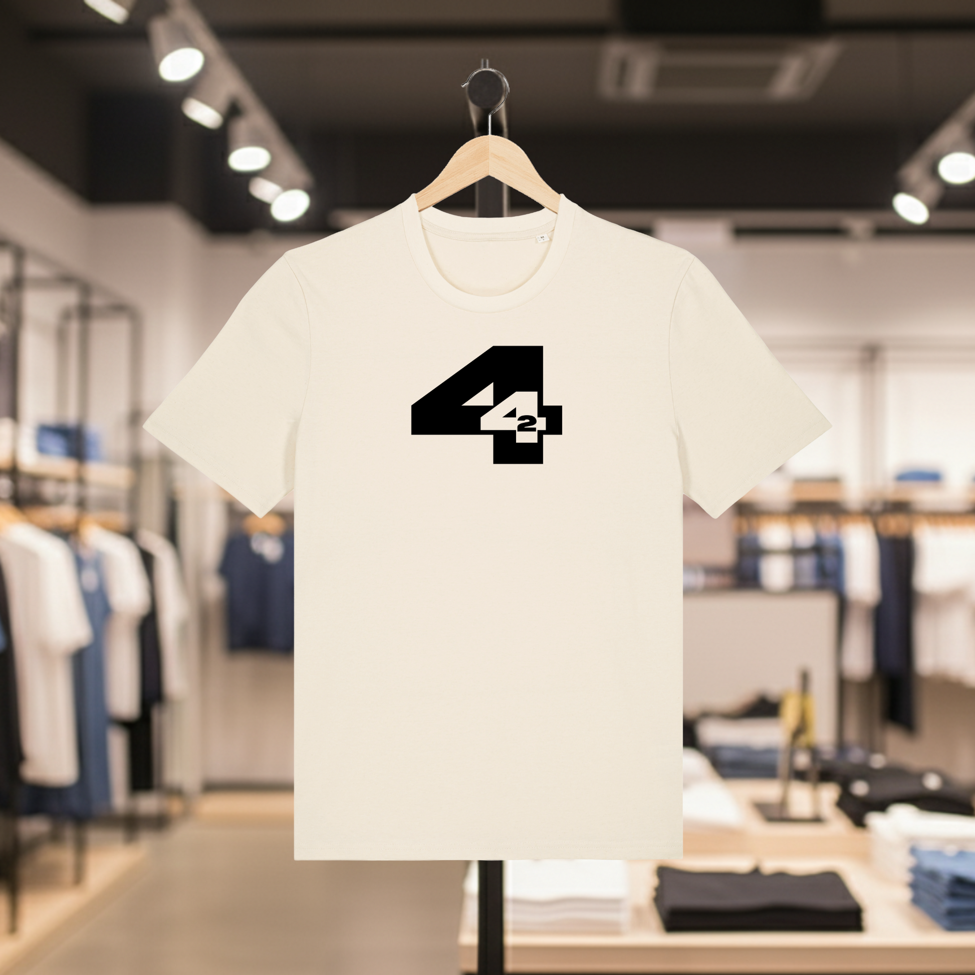 Natural t-shirt with a white  '442' design on a hanger in a store setting