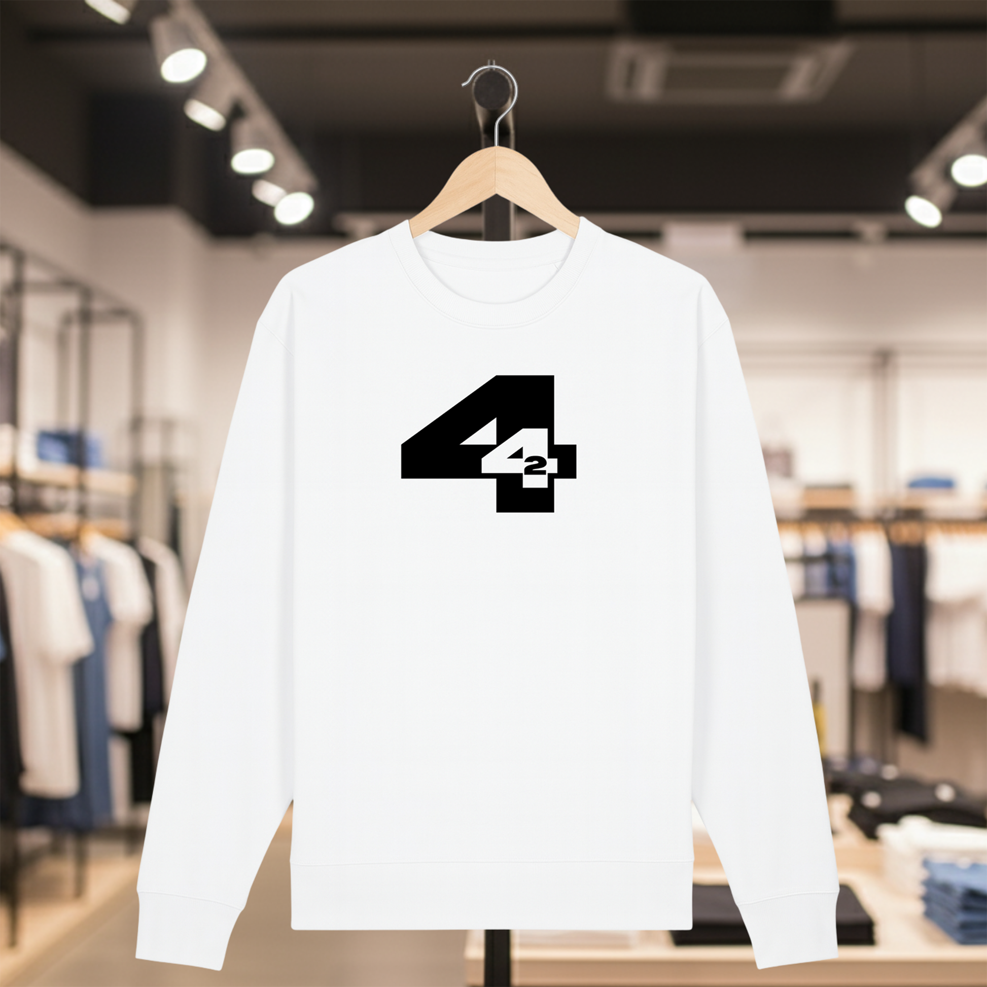 White sweatshirt with 442 design on a hanger in a store setting