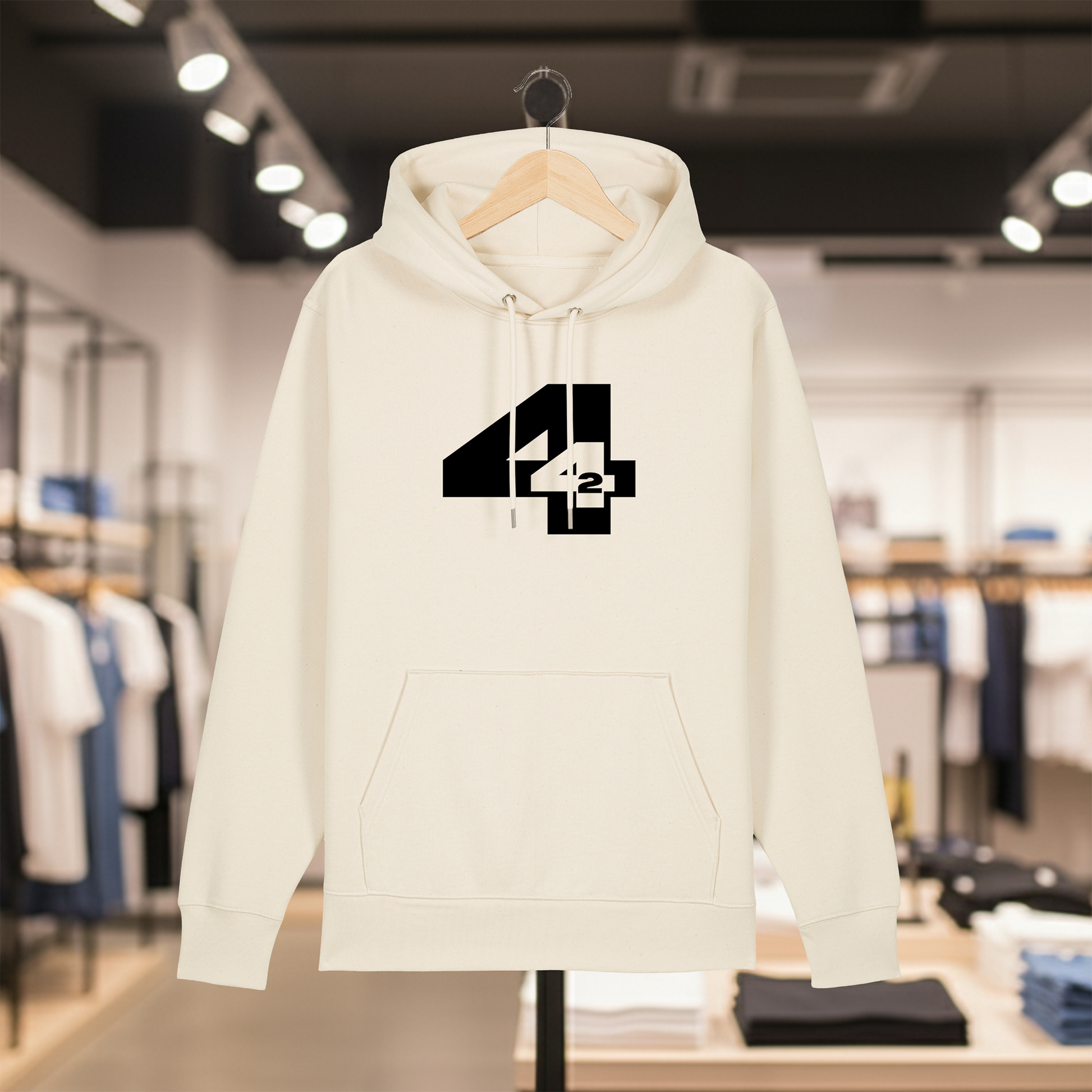 Natural hoodie with a white text 442 on a hanger in a store setting