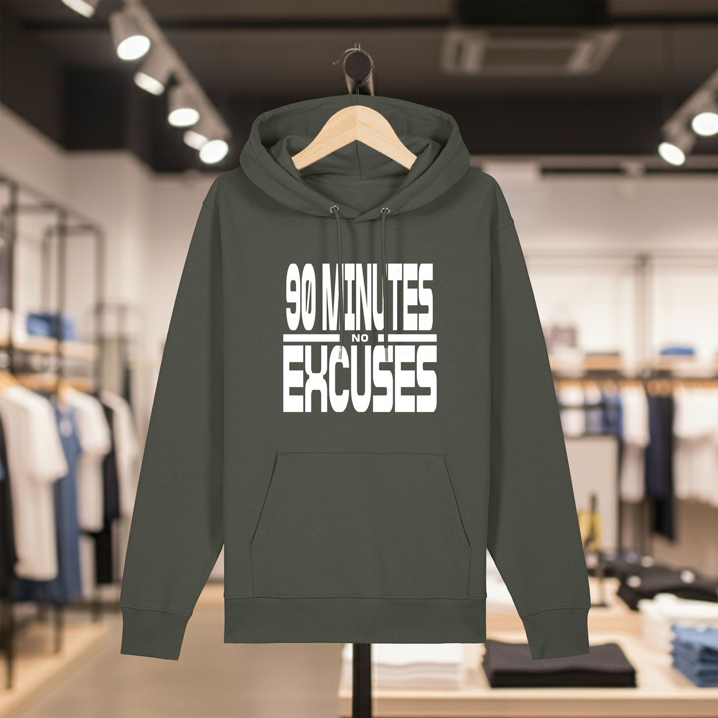 Khaki hoodie with text 90 MINUTES NO EXCUSES on a hanger in a store setting