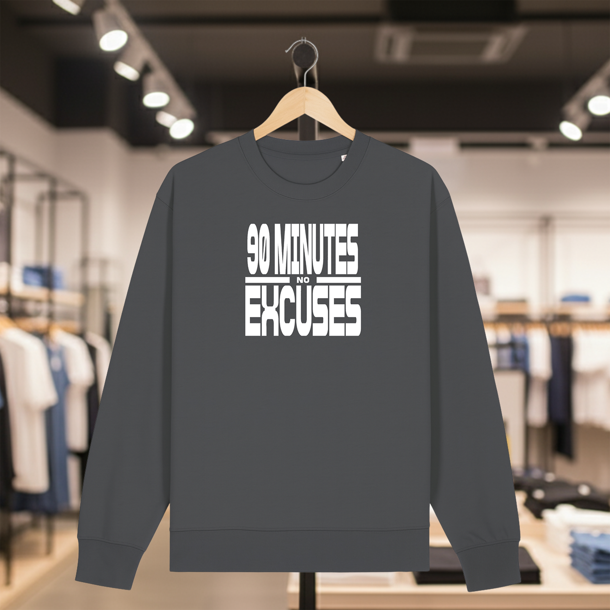 Grey sweatshirt with 90 MINUTES NO EXCUSES text on a hanger in a store setting