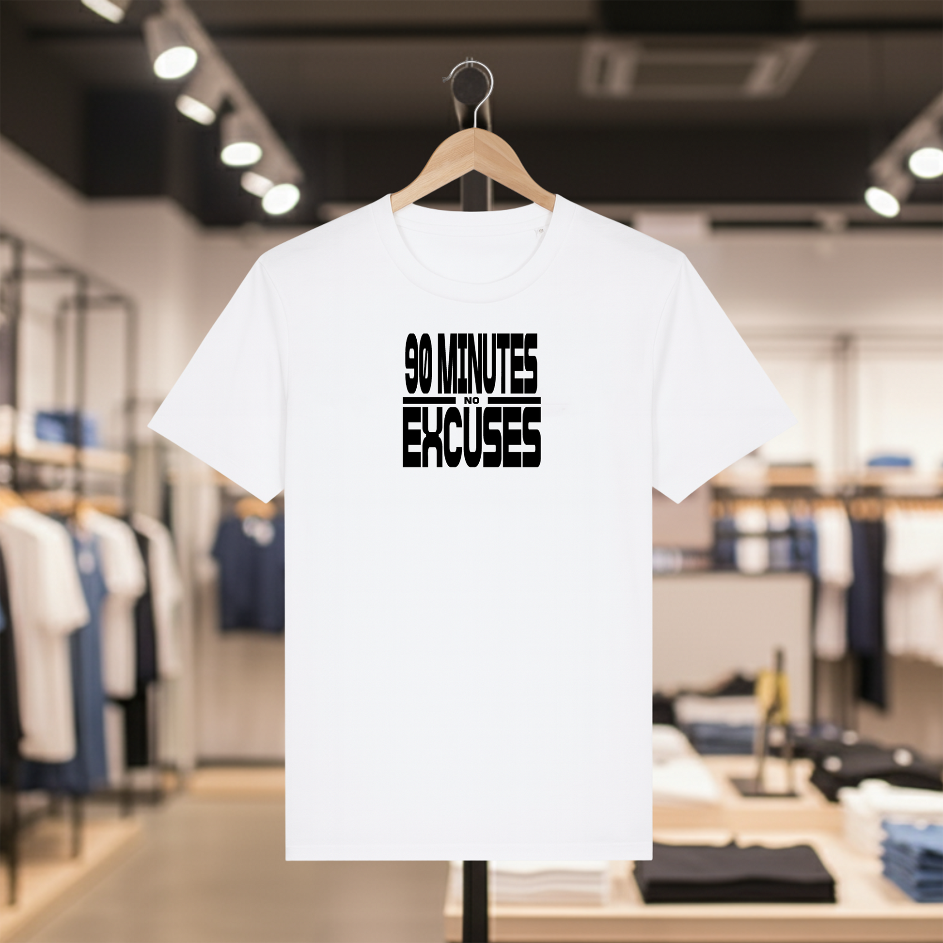 White t-shirt with '90 Minutes No Excuses' text on a hanger in a clothing store.