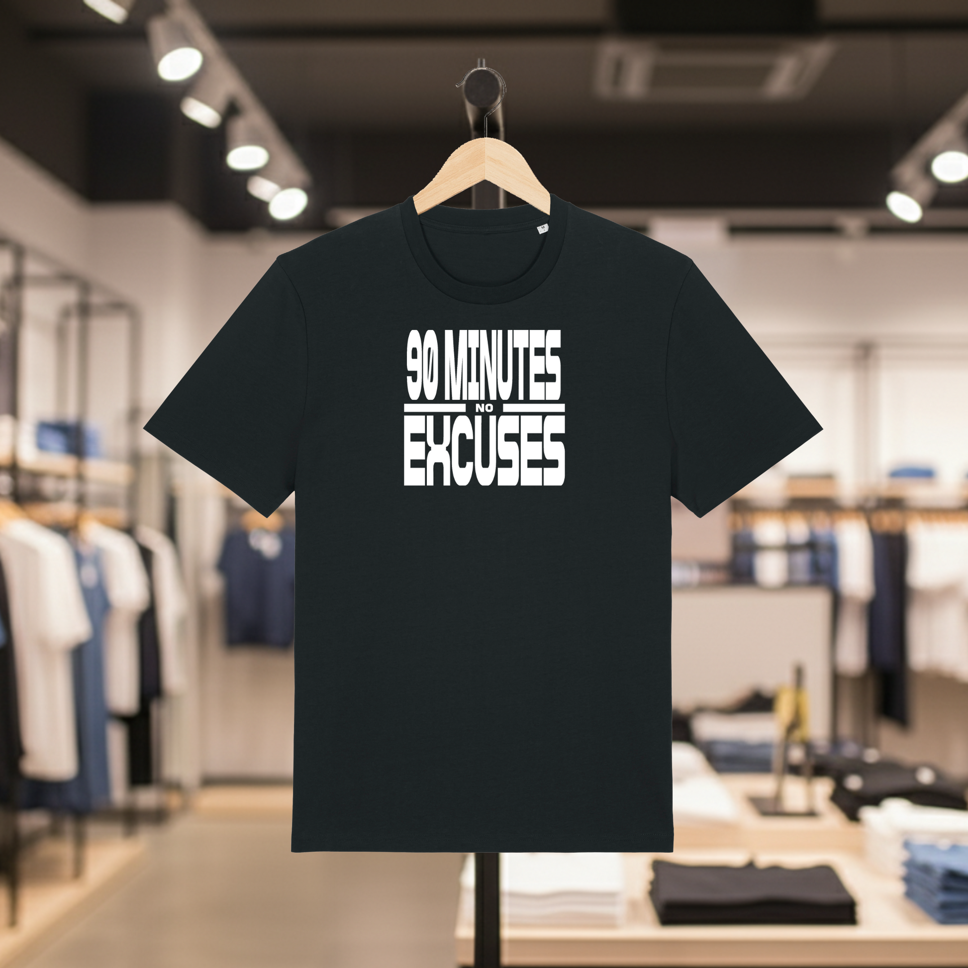 Black t-shirt with '90 Minutes No Excuses' text on a hanger in a store setting