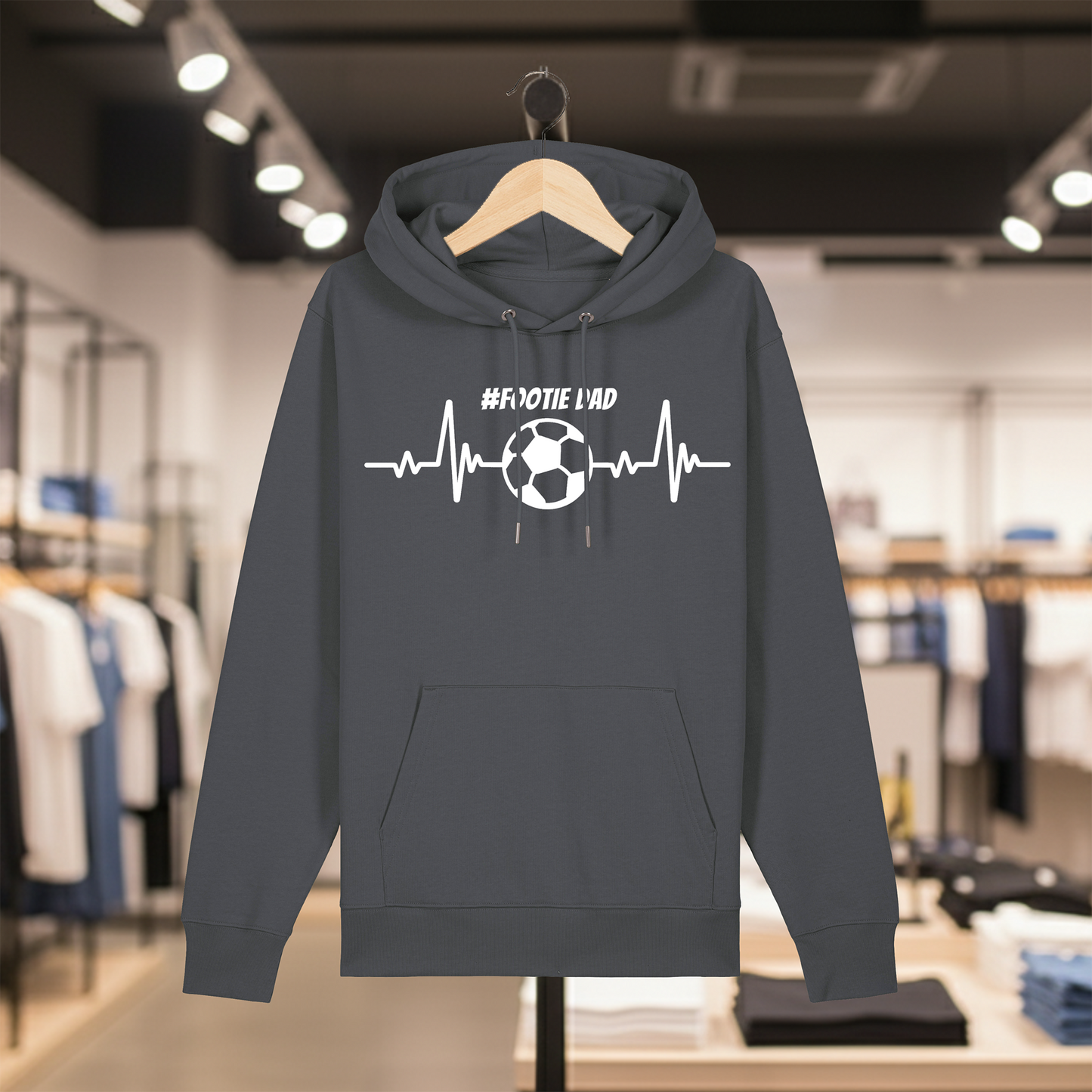 Grey hoodie with white text #FOOTIE DAD on a hanger in a store setting