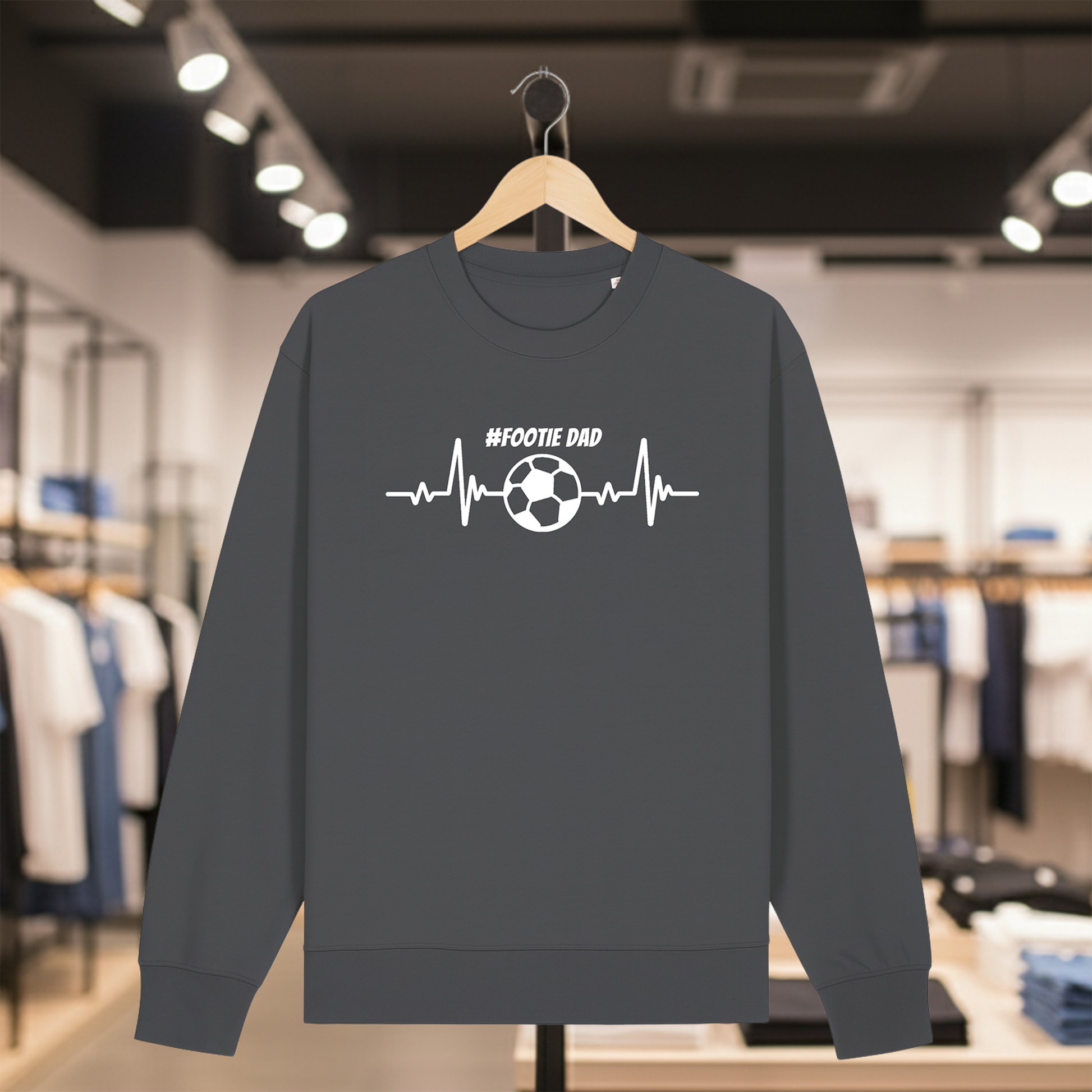 Grey sweatshirt with a white #FOOTIE DAD text on a hanger in a store setting