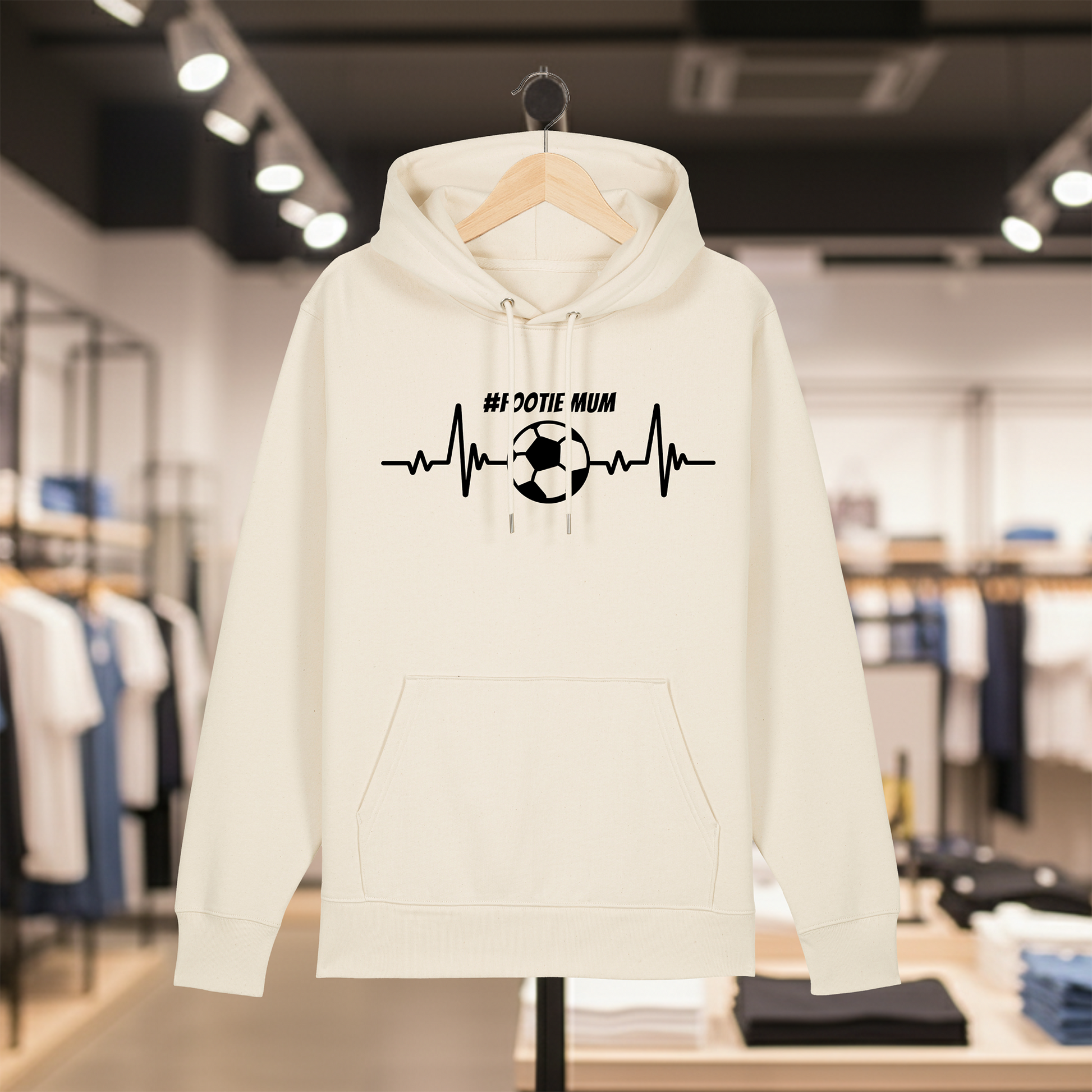 Natural hoodie with text #FOOTIE MUM on a hanger in a store setting