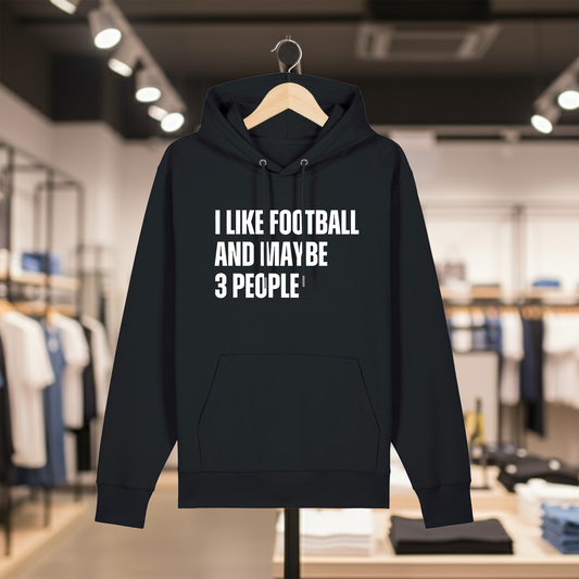 Black hoodie with text I LIKE FOOTBALL AND MAYBE 3 PEOPLE on a hanger in a store setting.