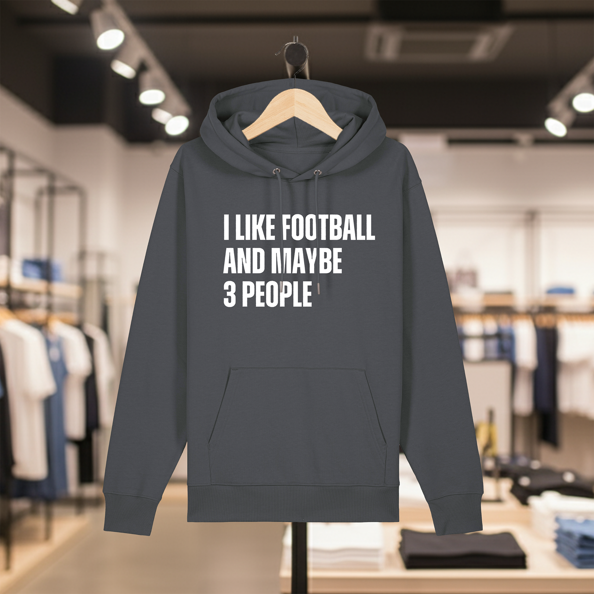 Grey hoodie with text I LIKE FOOTBALL AND MAYBE 3 PEOPLE on a hanger in a store setting.