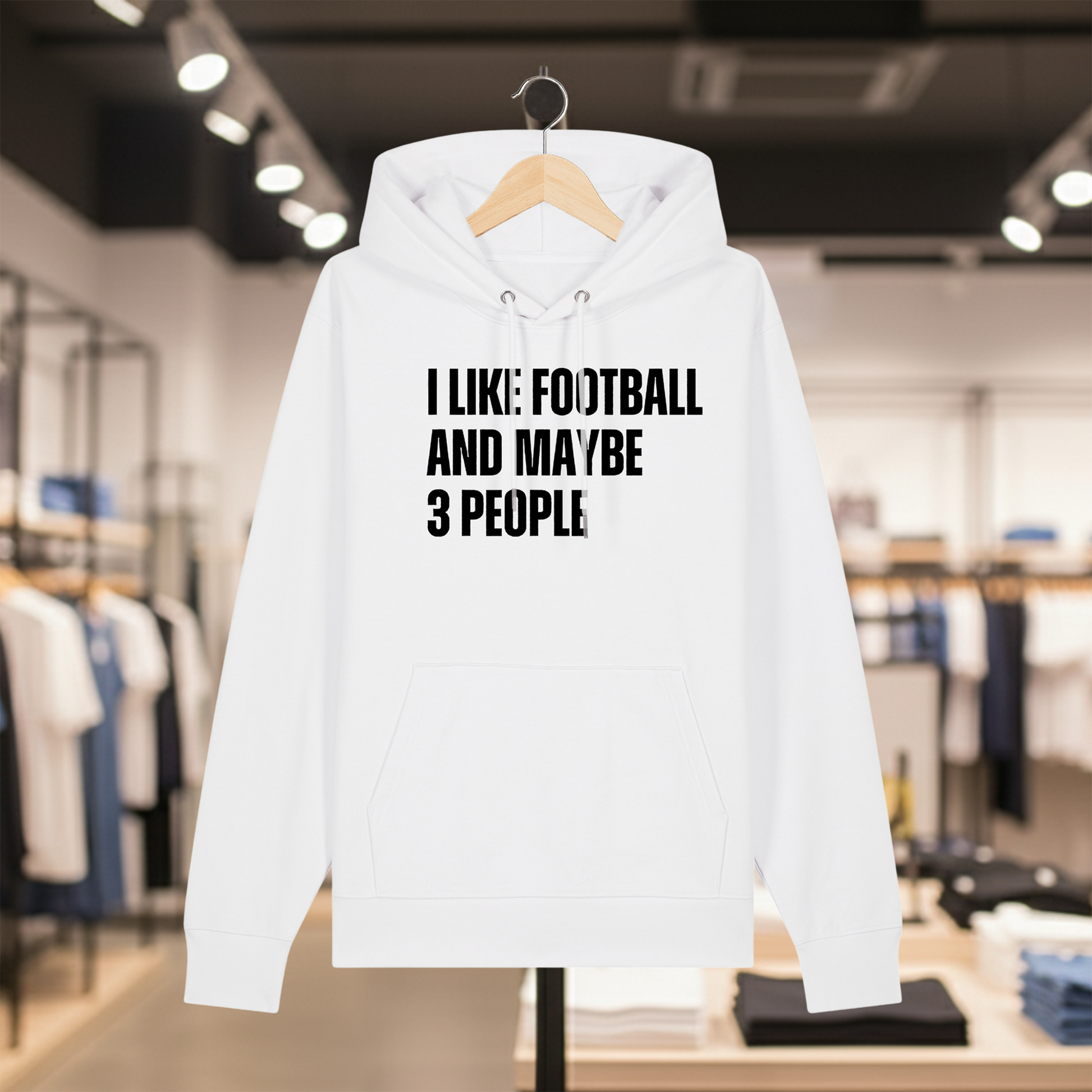 White hoodie with text I LIKE FOOTBALL AND MAYBE 3 PEOPLE on a hanger in a store setting.