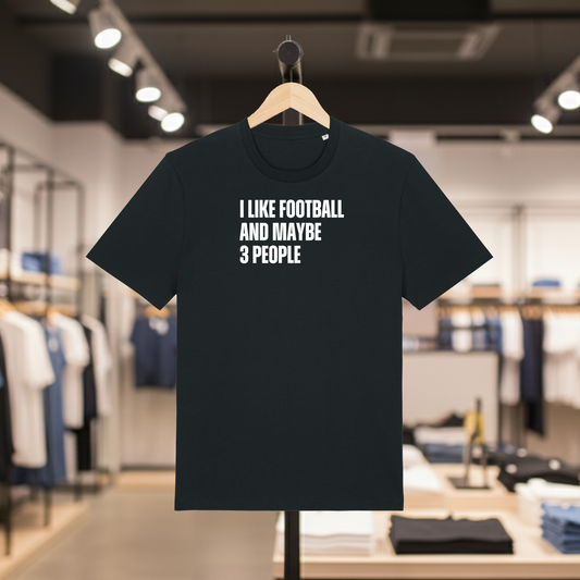 Black t-shirt with I Like Football And Maybe 3 People text on a hanger in a store.