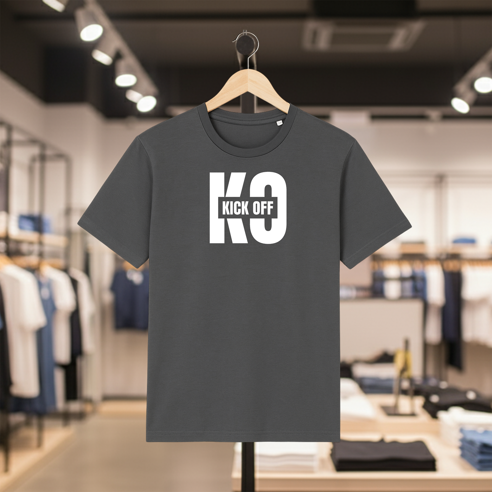 Grey t-shirt with KICK OFF text on a hanger in a store setting
