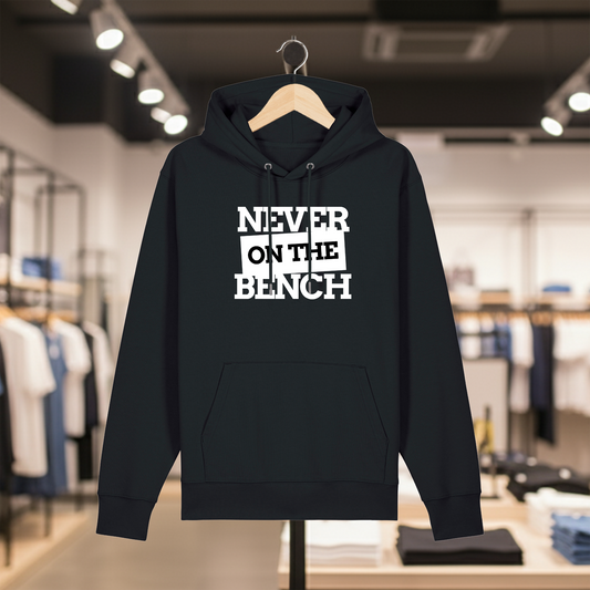 Black hoodie with text NEVER ON THE BENCH on a hanger in a store setting