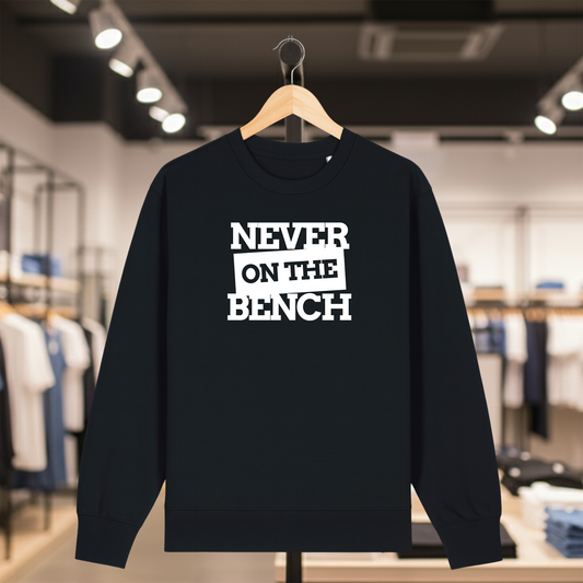 Black sweatshirt with NEVER ON THE BENCH text on a hanger in a store setting