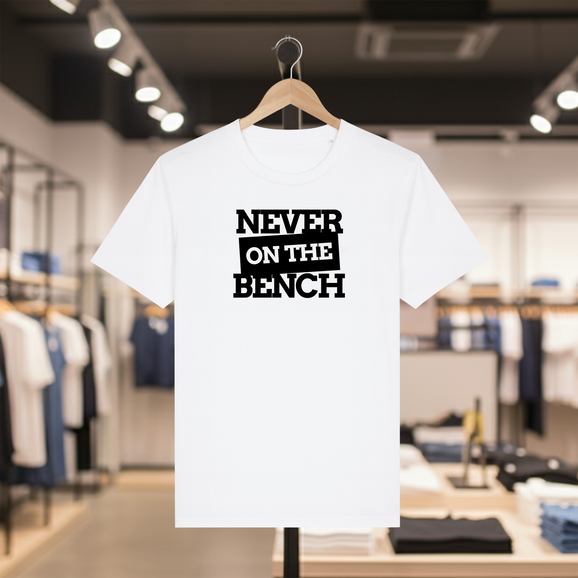 White t-shirt with Never on the Bench text on a hanger in a store setting