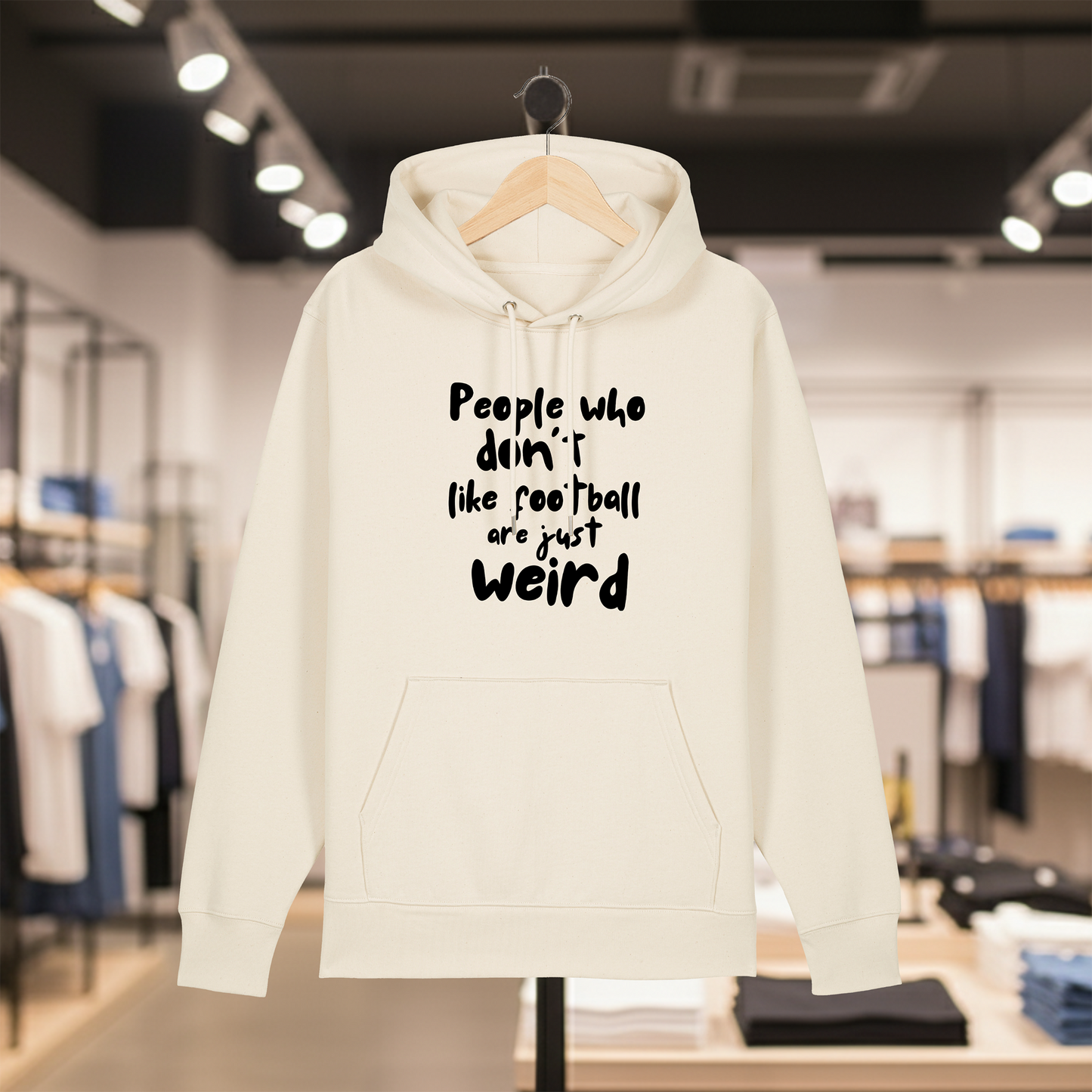 Natural hoodie with text PEOPLE WHO DON'T LIKE FOOTBALL ARE JUST WEIRD on a hanger in a store setting