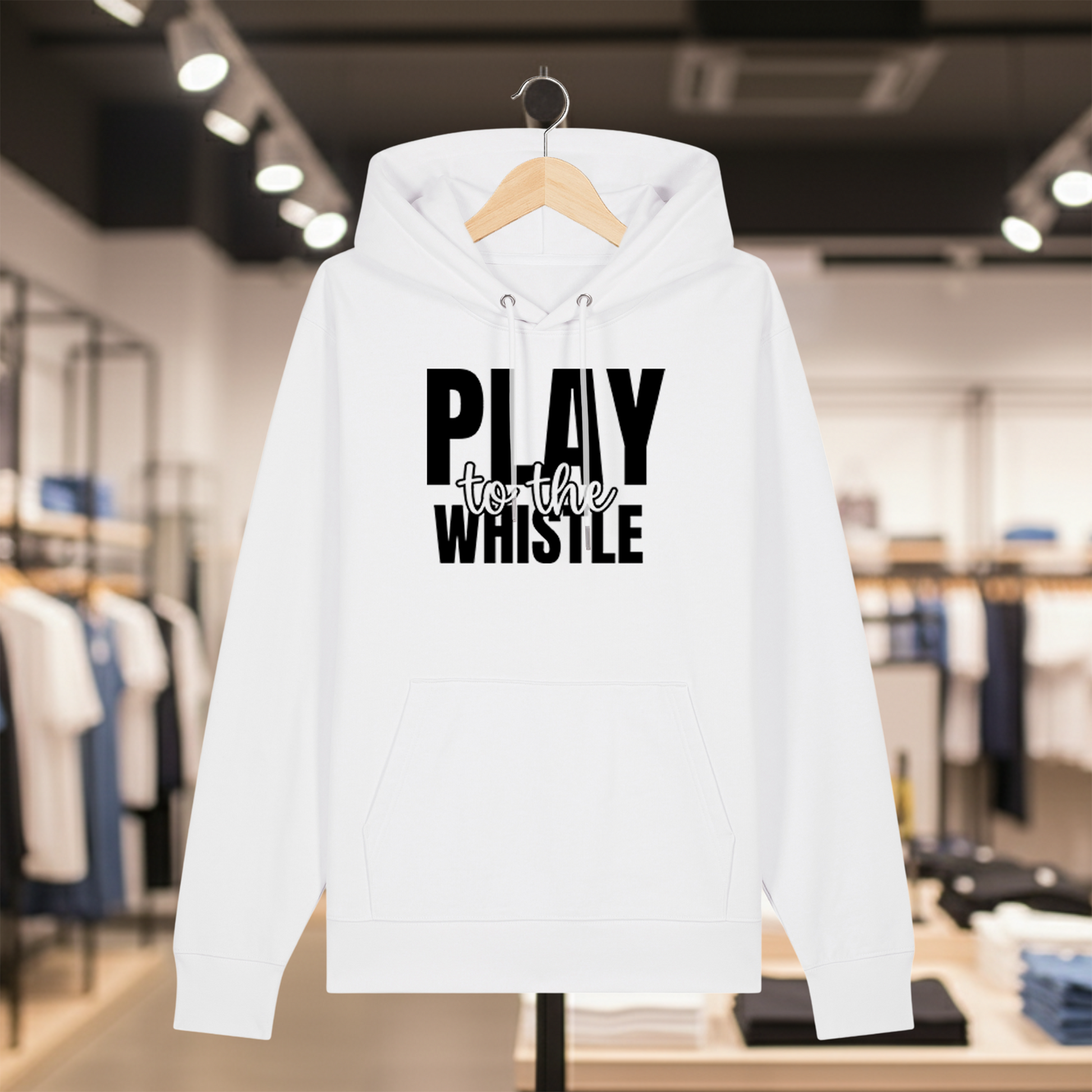 White hoodie with text PLAY TO THE WHISTLE on a hanger in a store setting