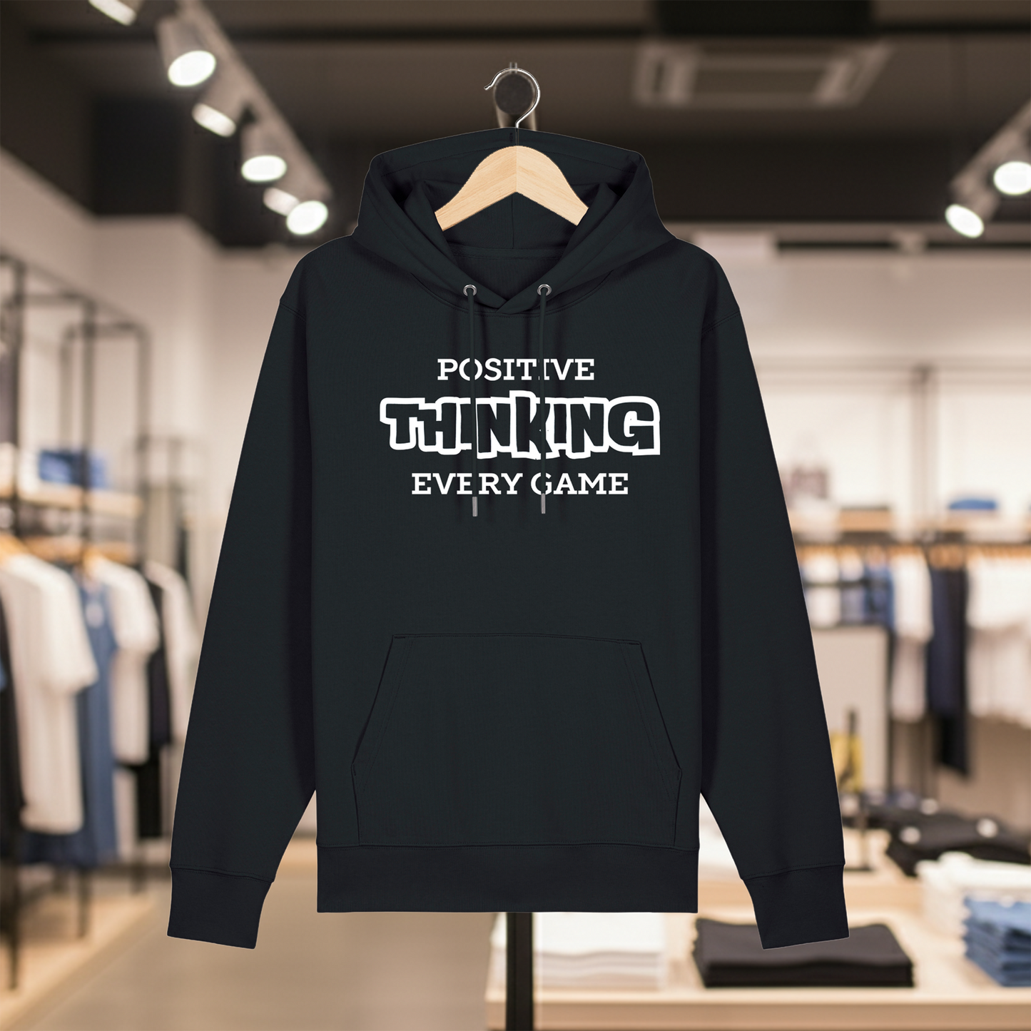Black hoodie with text POSITIVE THINKING EVERY GAME on a hanger in a store setting