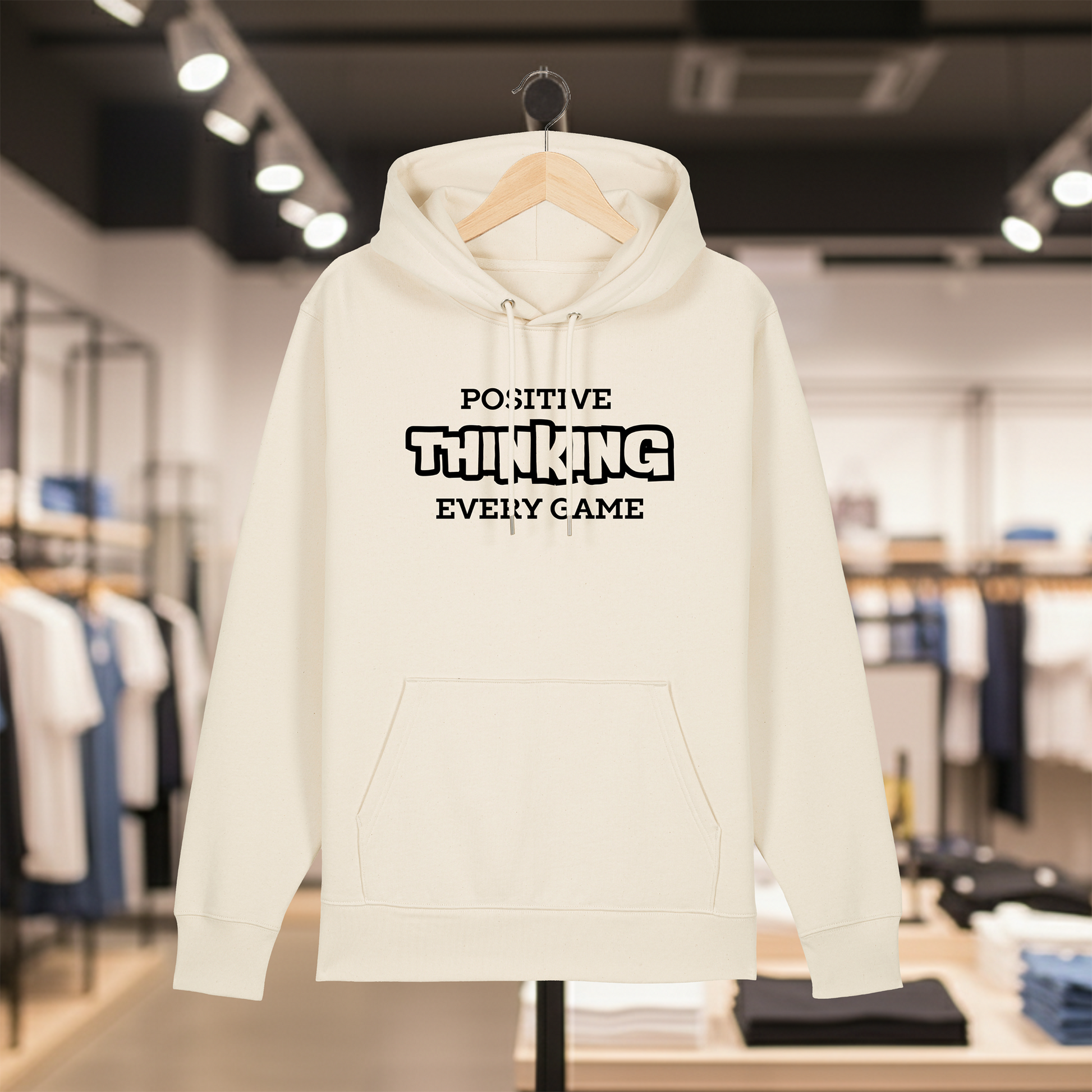 Natural hoodie with text POSITIVE THINKING EVERY GAME on a hanger in a store setting