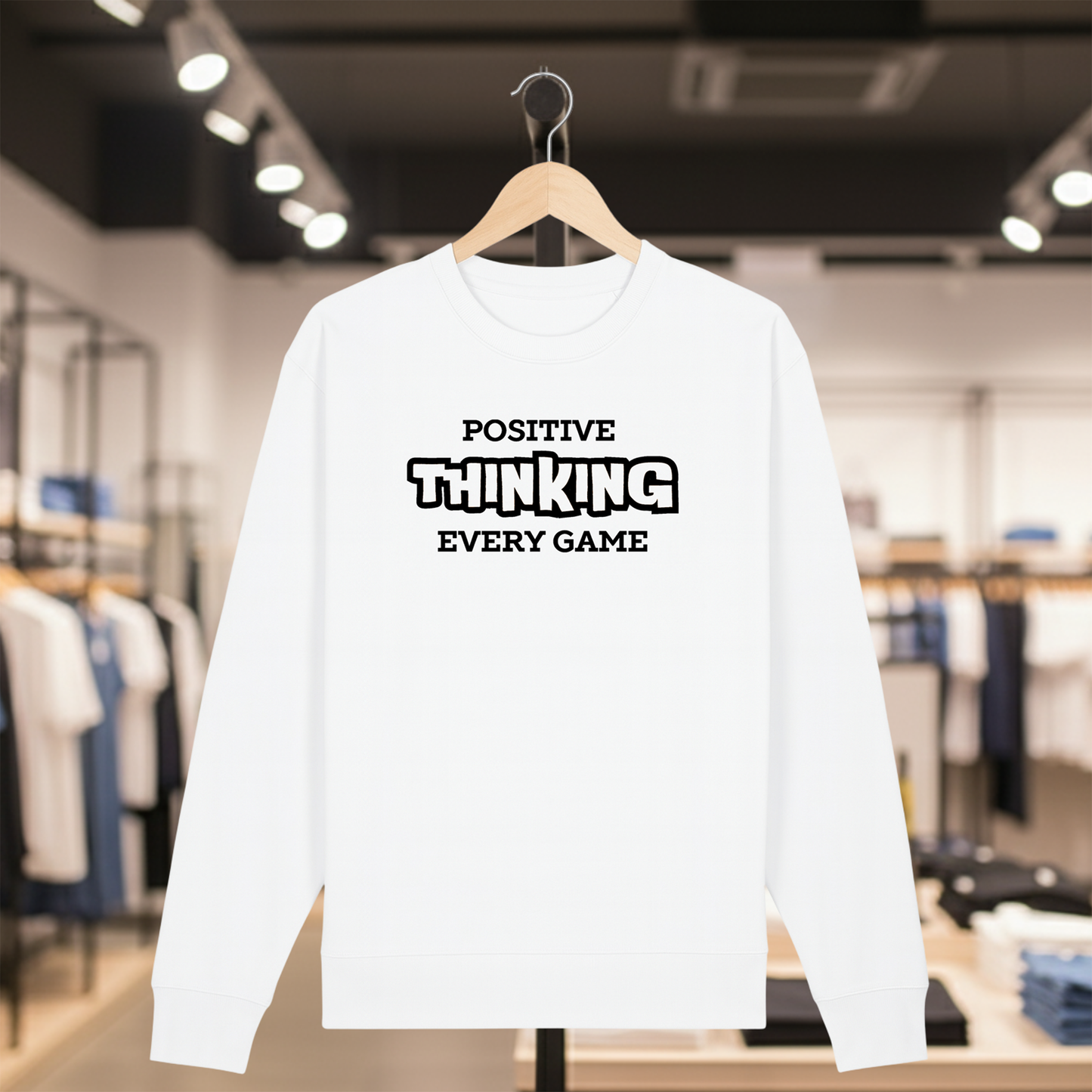 White sweatshirt with POSITIVE THINKING EVERY GAME text on a hanger in a store setting