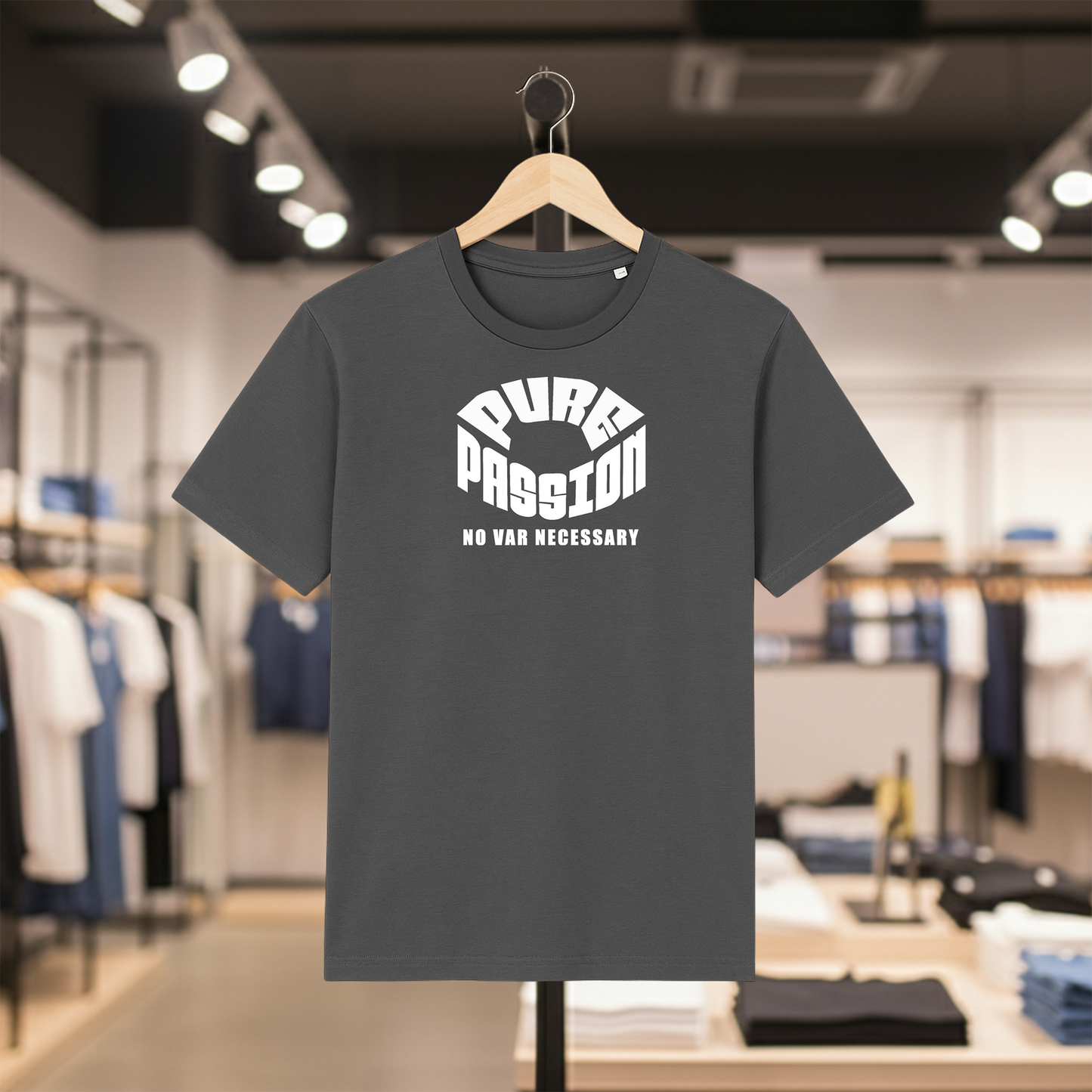 Grey t-shirt with white text PURE PASSION, NO VAR NECESSARY on a hanger in a store setting
