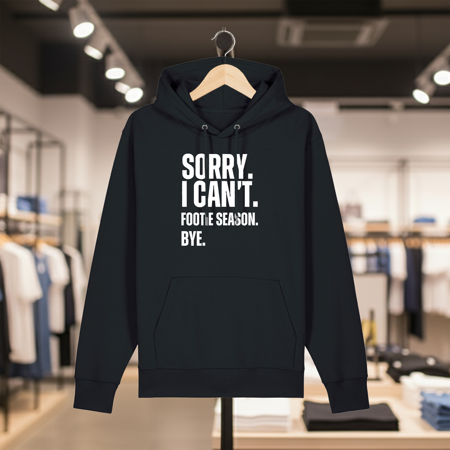 Black hoodie with text SORRY. I CAN'T. FOOTIE SEASON. BYE. on a hanger in a store setting