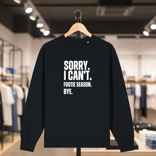 Black sweatshirt with white text SORRY. I CAN'T. FOOTIE SEASON. BYE. on a hanger in a store setting
