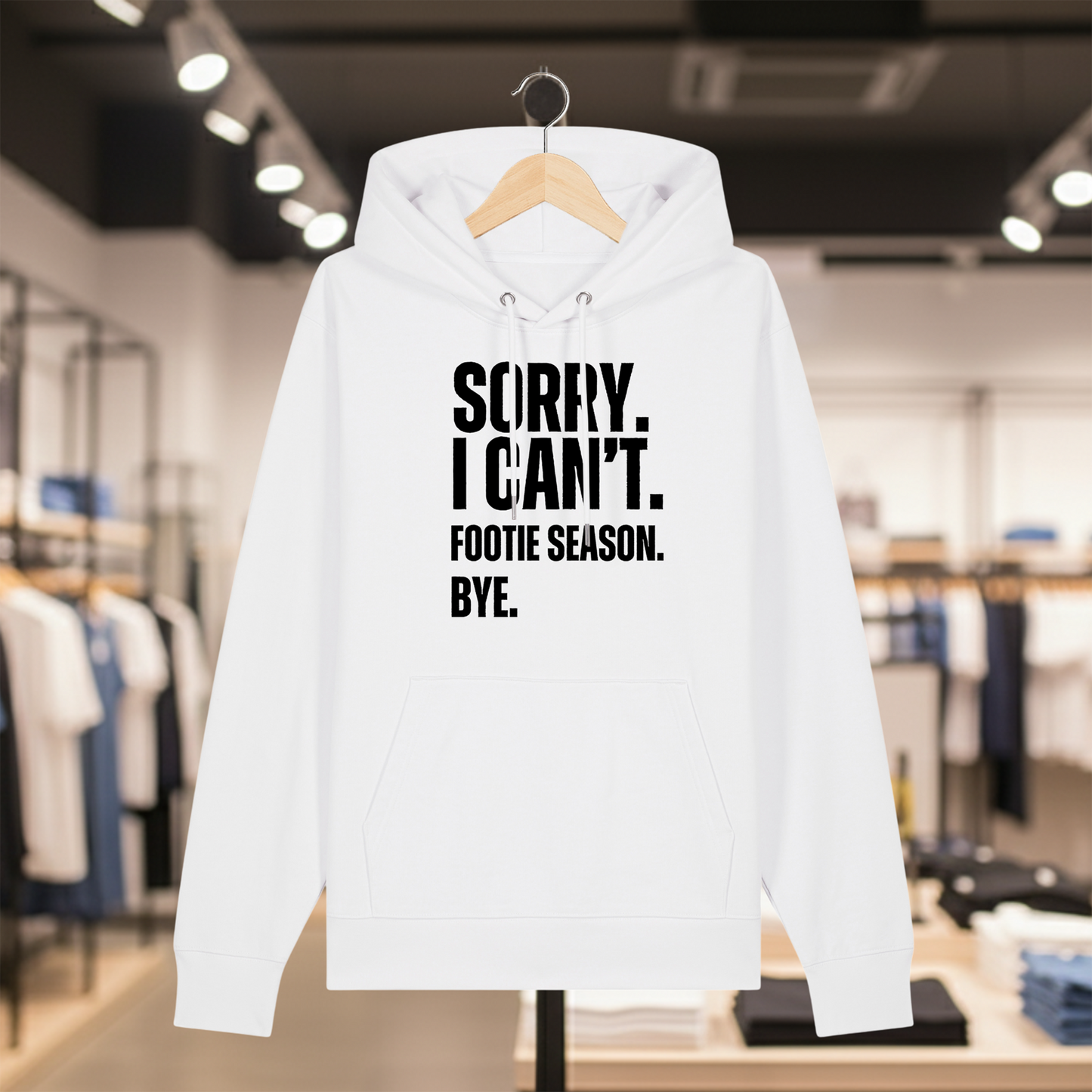 White hoodie with text SORRY. I CAN'T. FOOTIE SEASON. BYE. on a hanger in a store setting