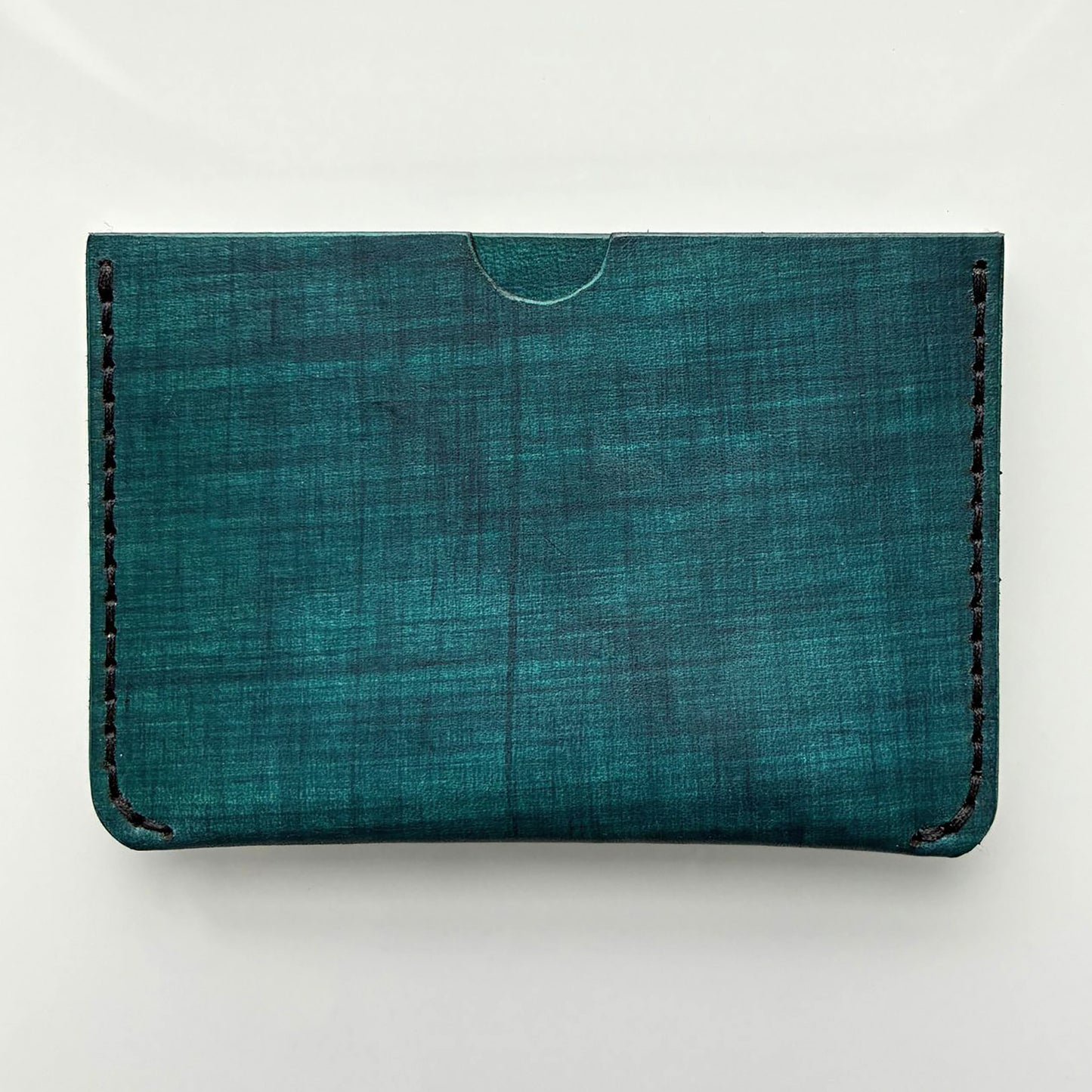Teal coloured card wallet on white background