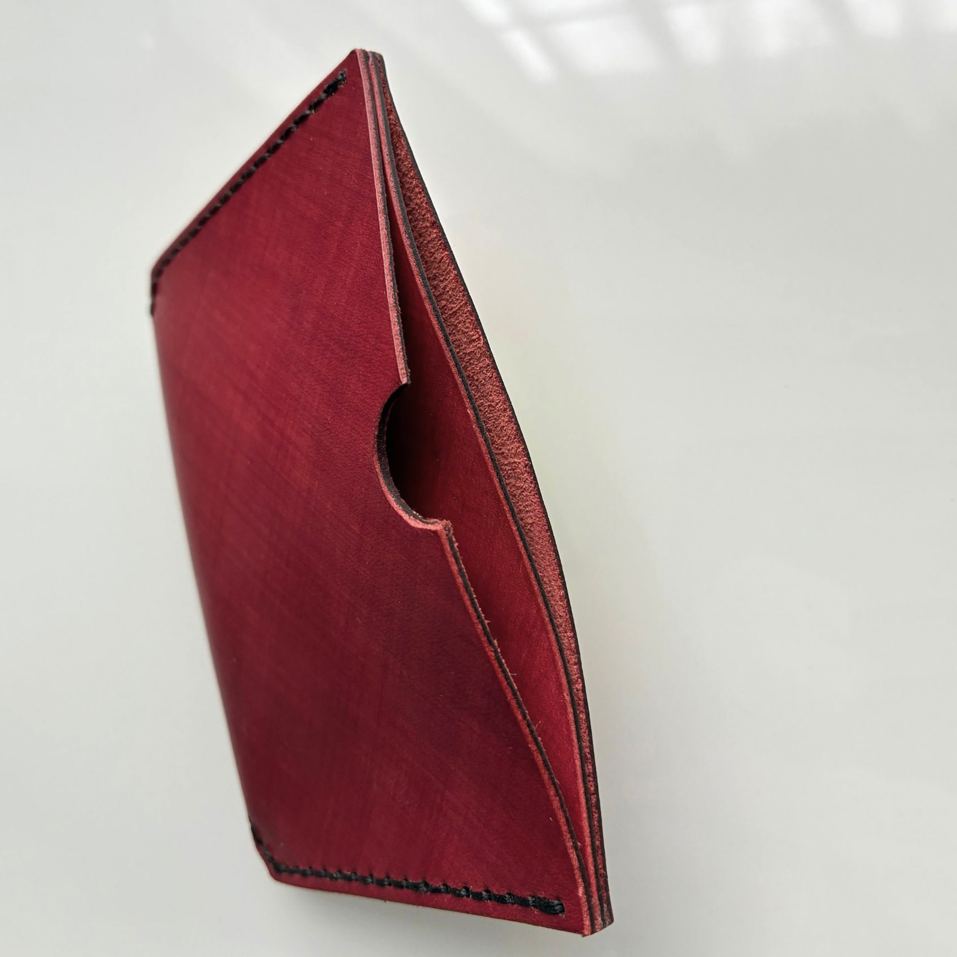 red card wallet showing card slots on a white background