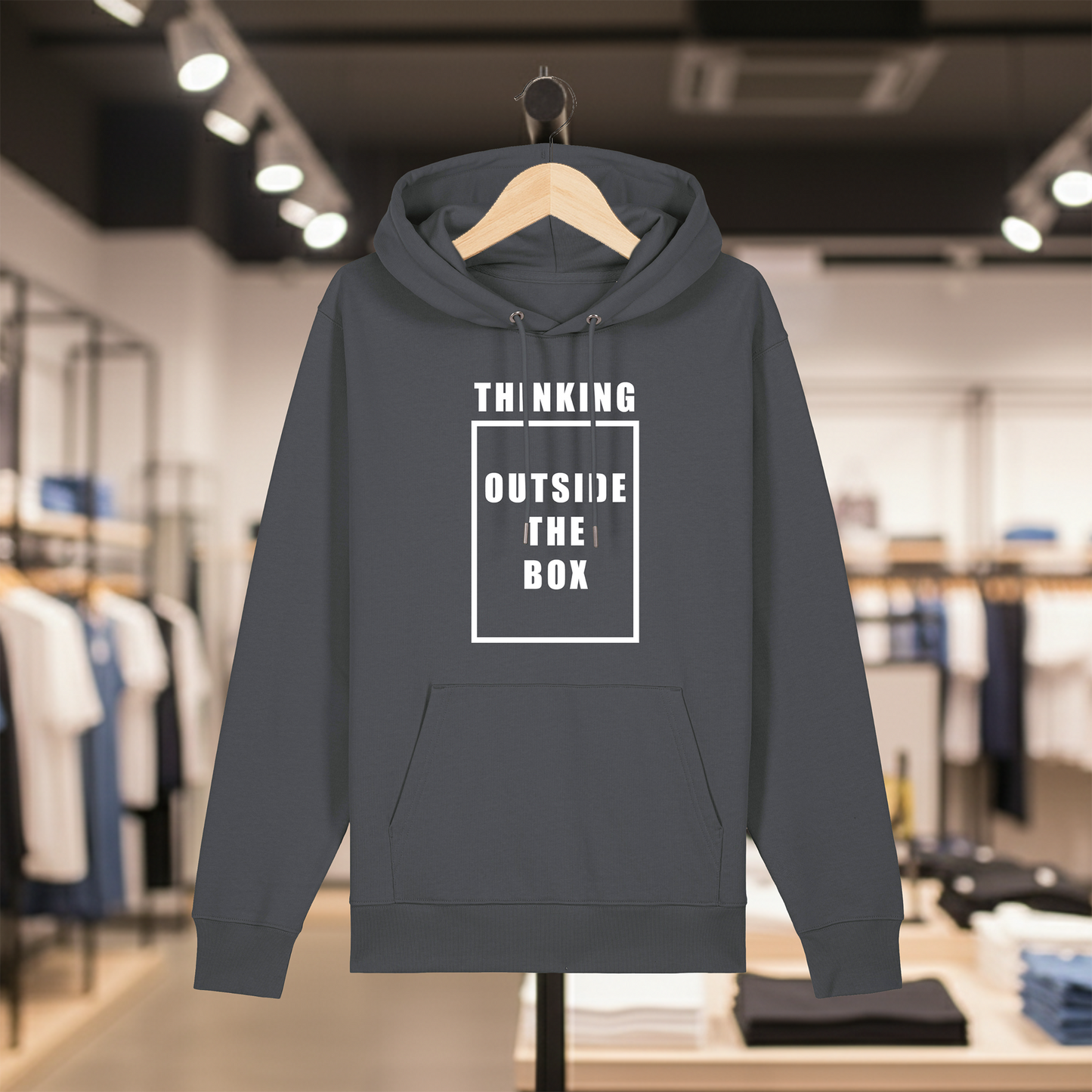 Grey hoodie with text THINKING OUTSIDE THE BOX on a hanger in a store setting