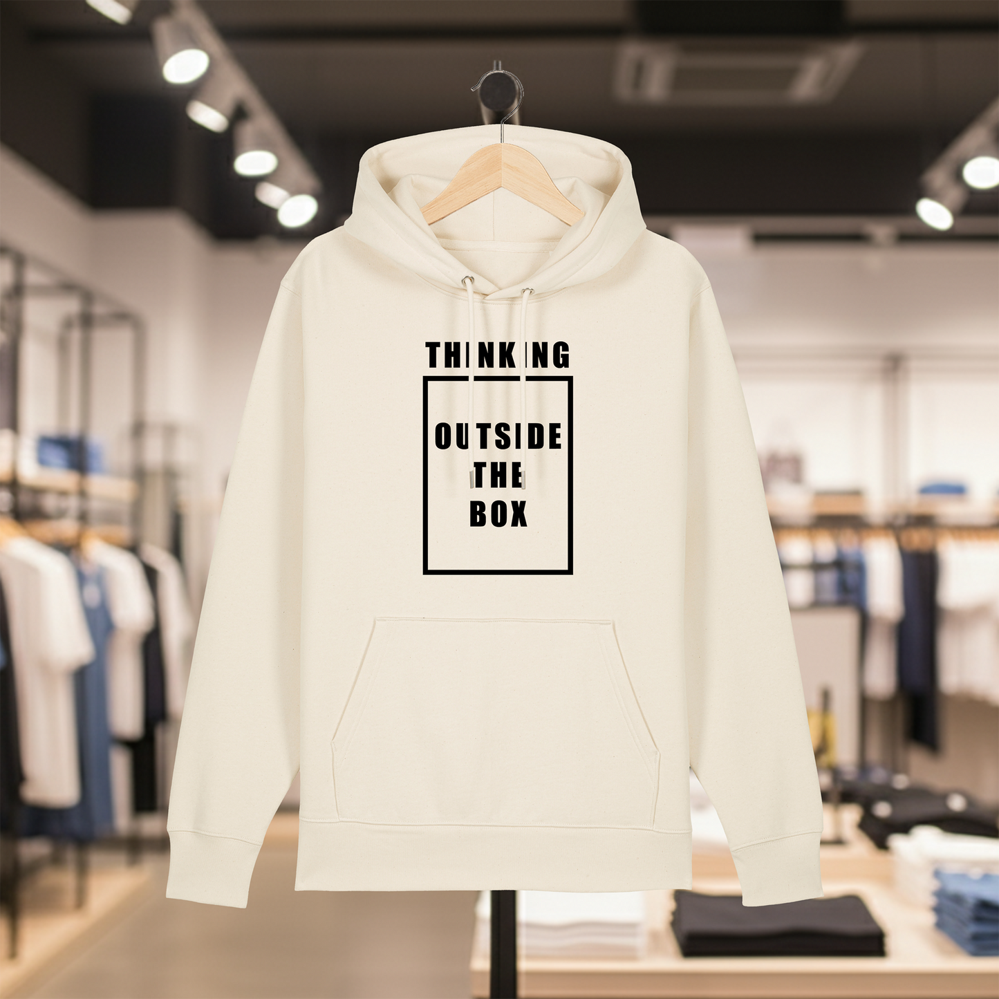 Natural hoodie with text THINKING OUTSIDE THE BOX on a hanger in a store setting