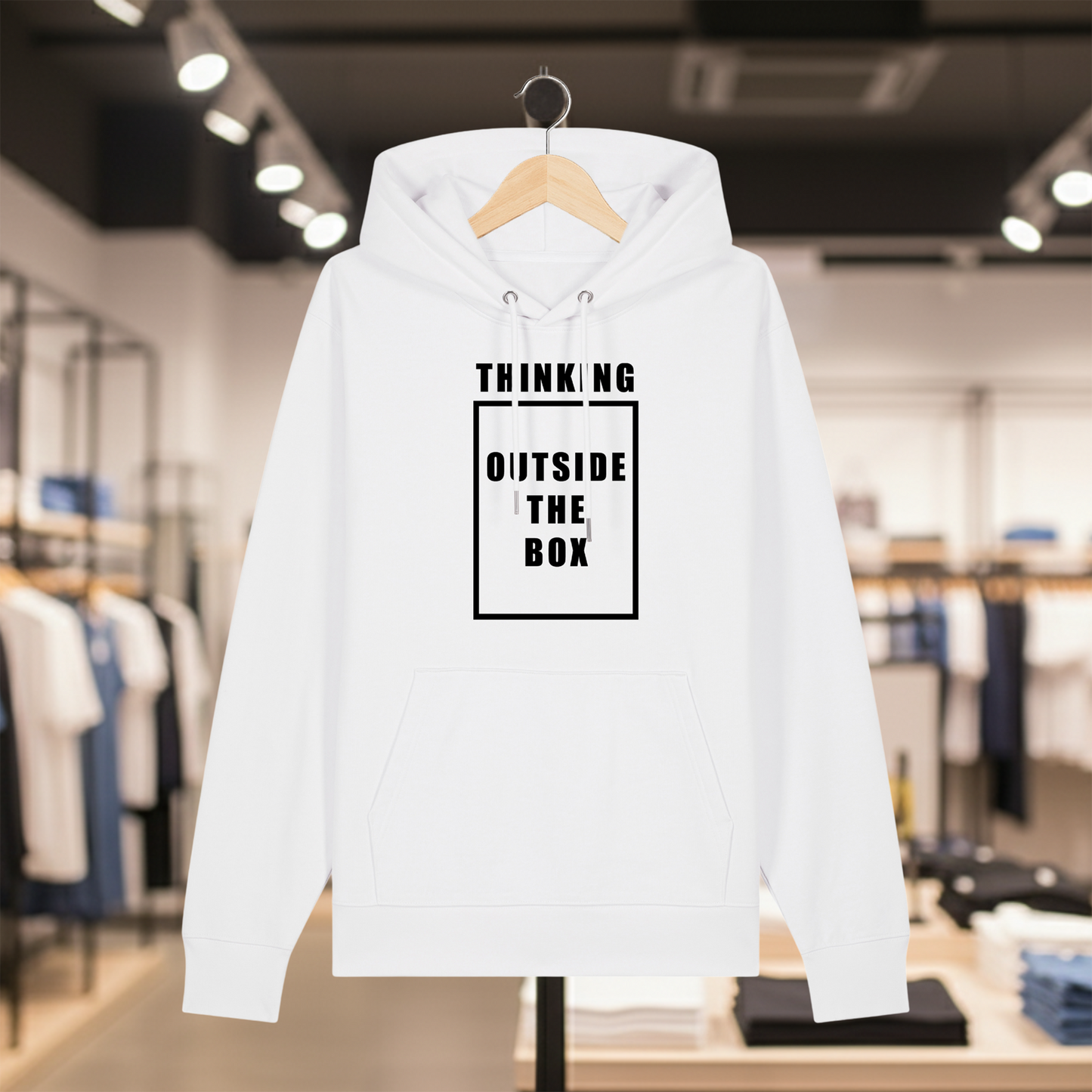White hoodie with text THINKING OUTSIDE THE BOX on a hanger in a store setting