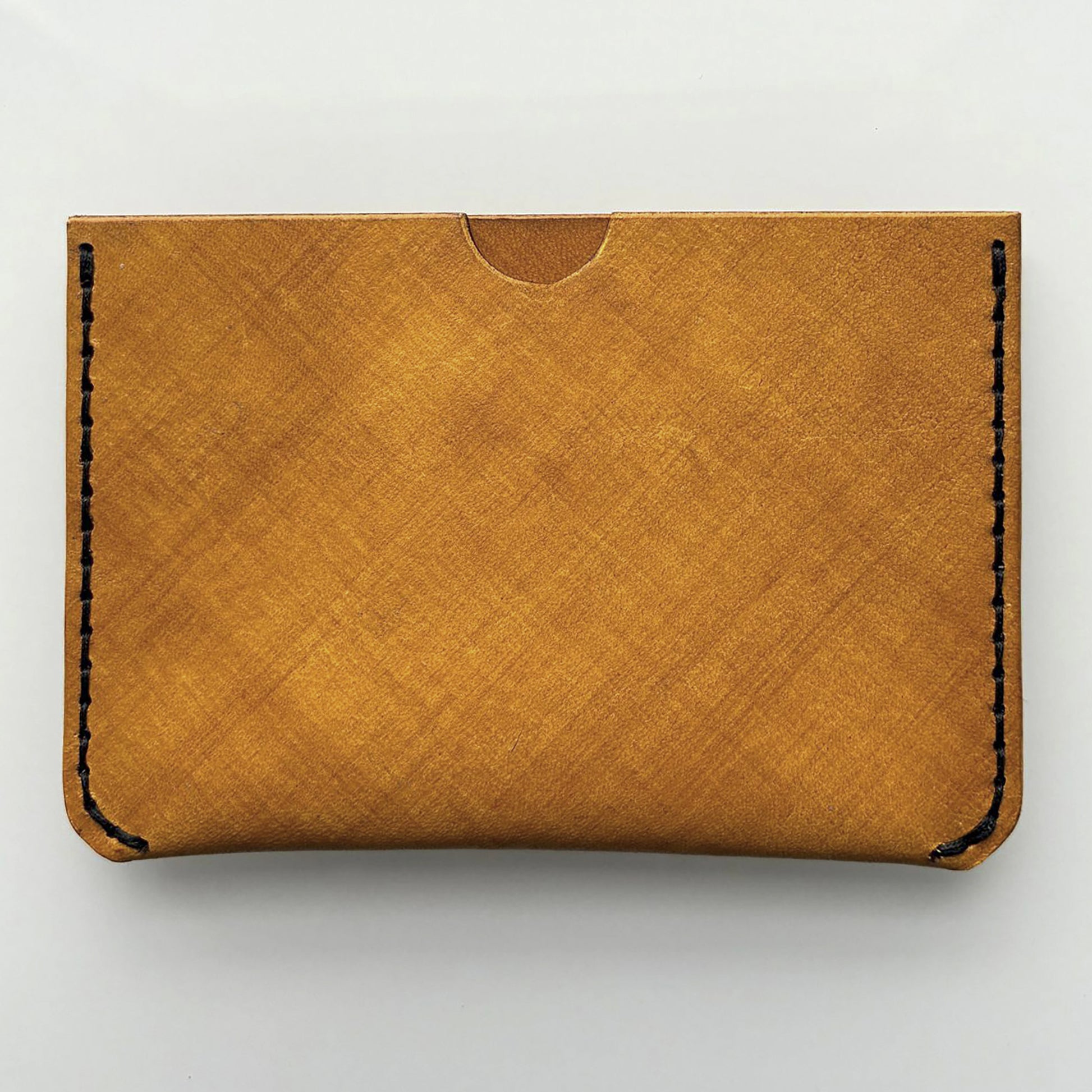 yellow leather card wallet on a bright background